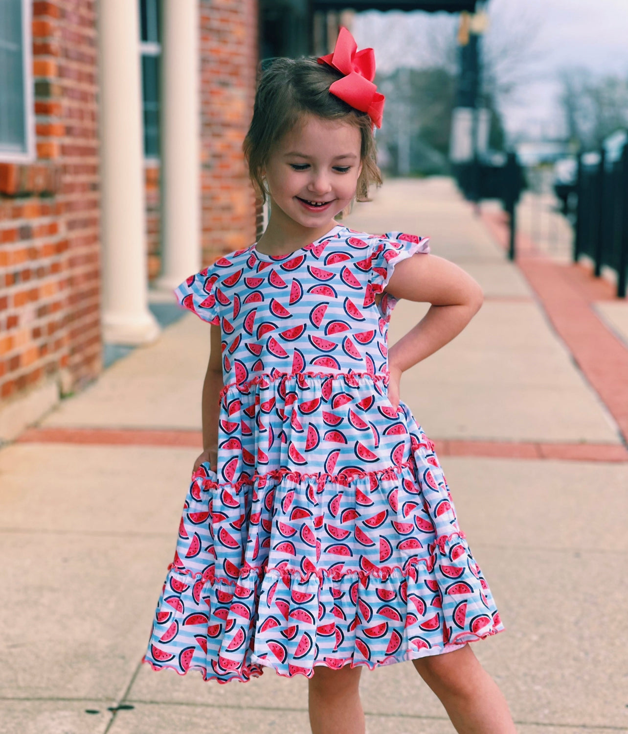 image of a cute small girl child wearing a printed dress.